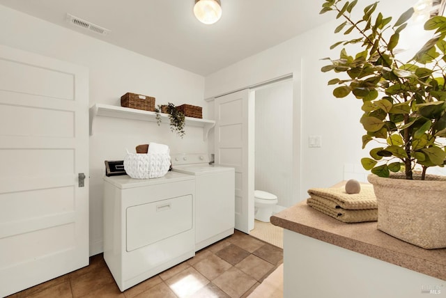 laundry area with washer and dryer and tile patterned floors