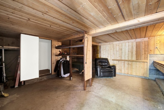 interior space featuring wooden walls and wooden ceiling