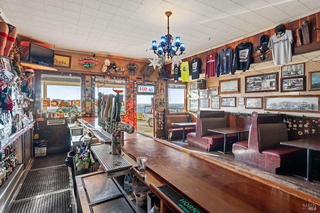 interior space featuring a notable chandelier and wood walls