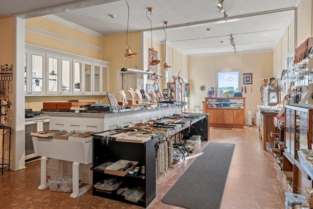 kitchen featuring hanging light fixtures, ornamental molding, a center island, and white cabinets