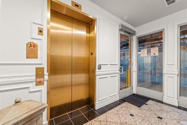 1120 Sonata Dr, Vallejo, CA 94591 - doorway featuring elevator, ornamental molding, wainscoting, a decorative wall, and granite floors