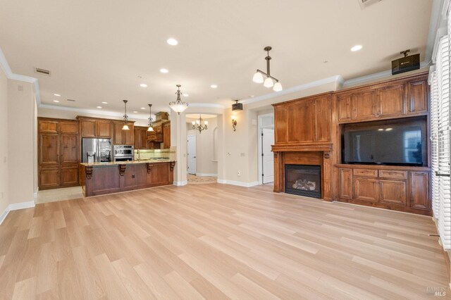 1120 Sonata Dr, Vallejo, CA 94591 - unfurnished living room featuring a chandelier, recessed lighting, baseboards, light wood-style flooring, and ornamental molding