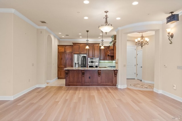 kitchen featuring pendant lighting, light wood-style flooring, stainless steel appliances, a breakfast bar, and crown molding