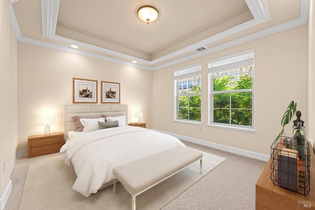 bedroom with a tray ceiling, light carpet, and baseboards