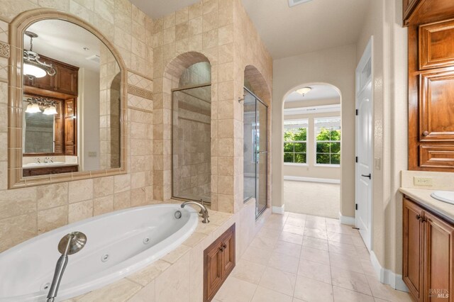 1120 Sonata Dr, Vallejo, CA 94591 - full bath with a shower stall, a jetted tub, vanity, tile patterned floors, and baseboards