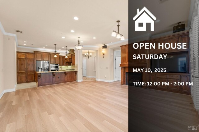 1120 Sonata Dr, Vallejo, CA 94591 - kitchen featuring stainless steel appliances, a chandelier, brown cabinetry, recessed lighting, and light wood finished floors