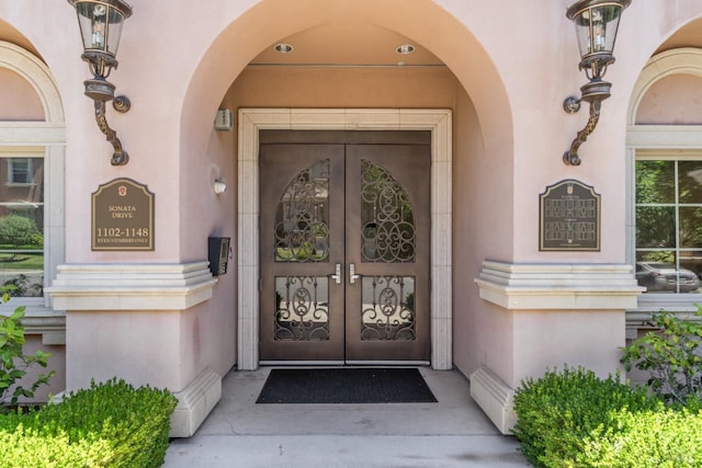 doorway to property with french doors and stucco siding