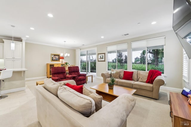 living room featuring ornamental molding and a chandelier