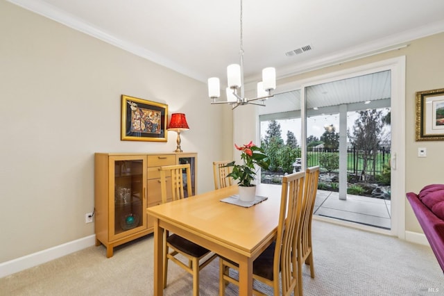 dining area with crown molding, light colored carpet, and a chandelier