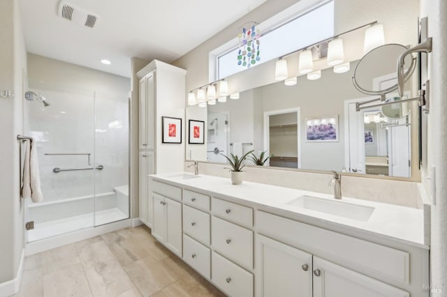 bathroom with vanity and a shower with shower door