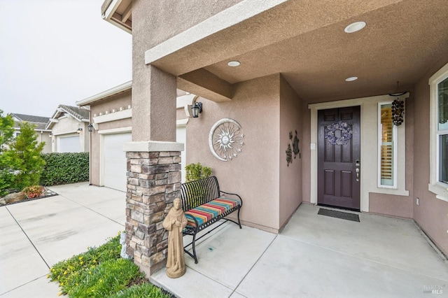 doorway to property with a garage