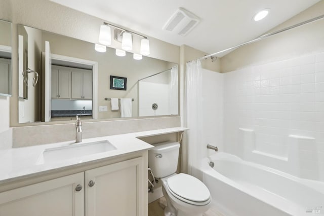 full bathroom with vanity, shower / bath combo, and toilet