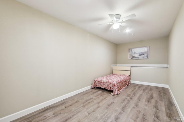 unfurnished bedroom with ceiling fan and light hardwood / wood-style flooring