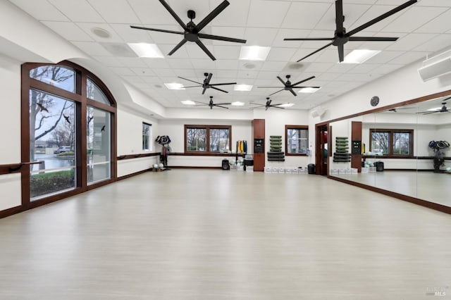 workout area featuring a drop ceiling and hardwood / wood-style floors