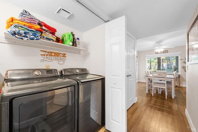 washroom featuring hardwood / wood-style floors, washing machine and clothes dryer, and ceiling fan