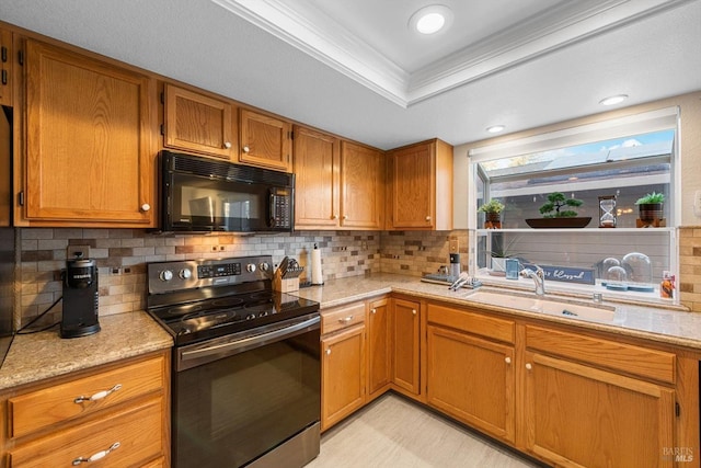 kitchen featuring electric stove, sink, light stone counters, ornamental molding, and a raised ceiling