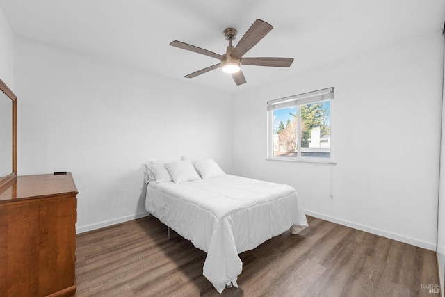 bedroom with ceiling fan and dark hardwood / wood-style flooring