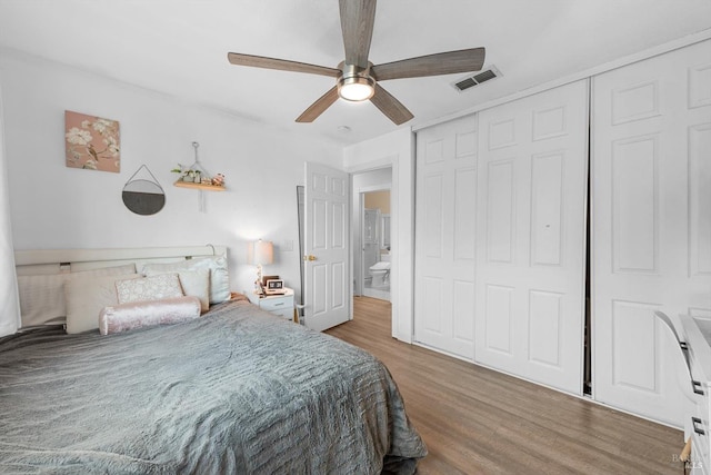 bedroom featuring hardwood / wood-style flooring, ceiling fan, and a closet