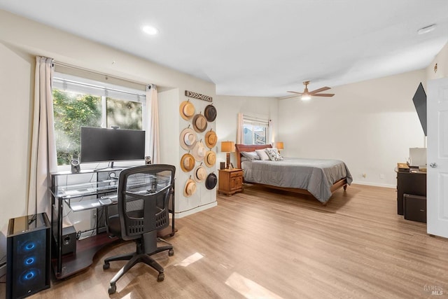 bedroom with ceiling fan and light hardwood / wood-style flooring