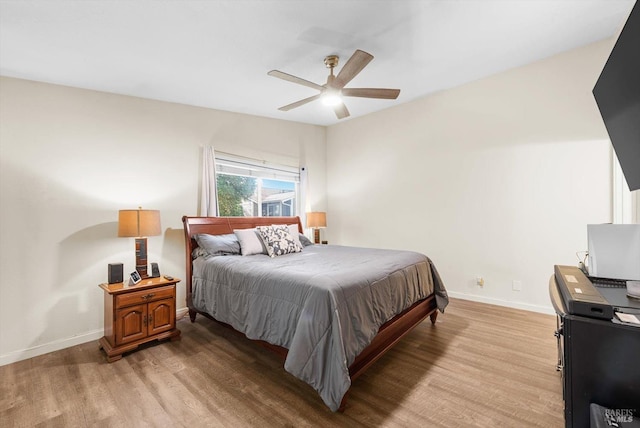 bedroom with light hardwood / wood-style floors and ceiling fan