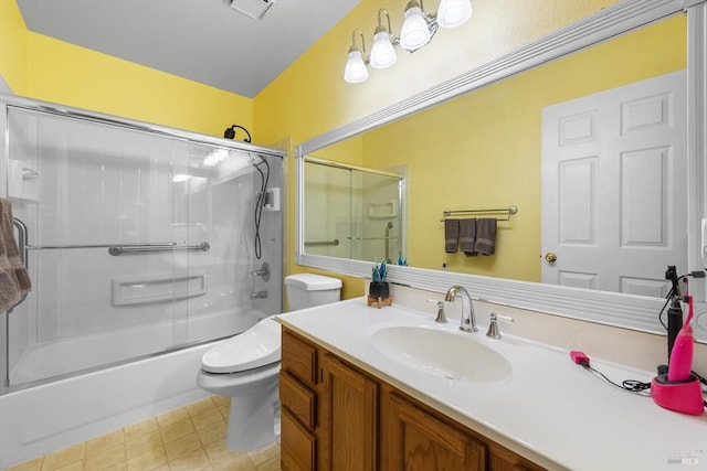 full bathroom with vanity, bath / shower combo with glass door, and toilet