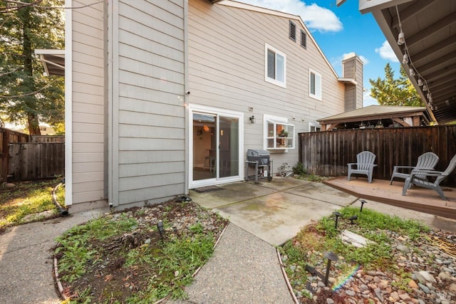 back of property with a patio and a gazebo