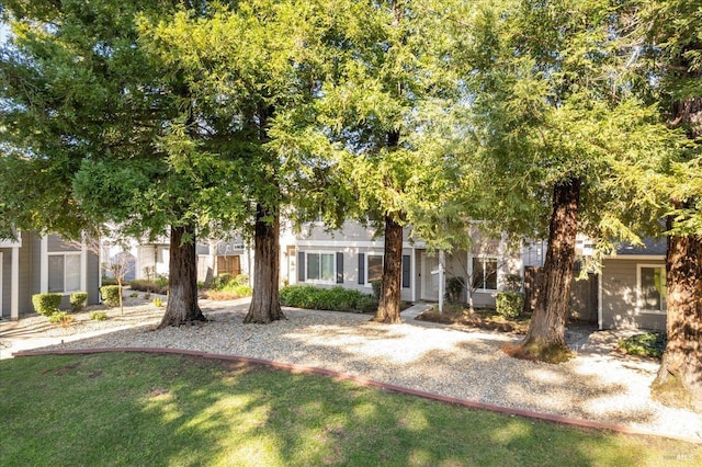 obstructed view of property featuring a front lawn