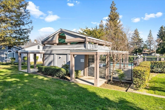 back of house featuring a fenced in pool and a lawn