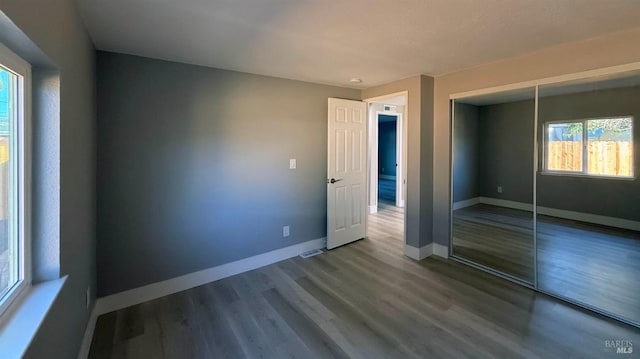 unfurnished room with hardwood / wood-style floors