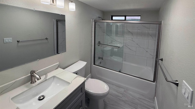 full bathroom featuring vanity, shower / bath combination with glass door, and toilet