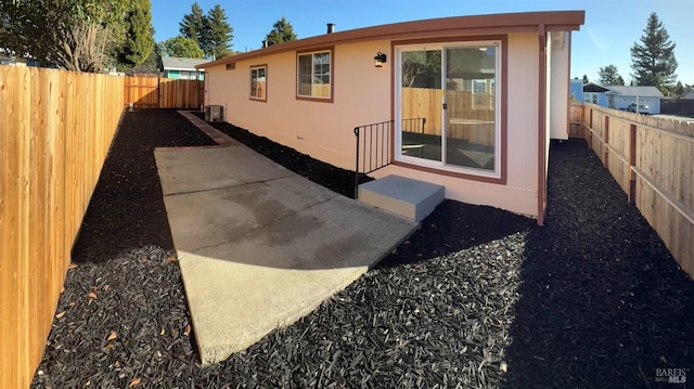 rear view of house featuring a patio area and central air condition unit