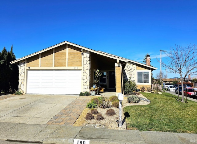 single story home featuring a garage and a front lawn