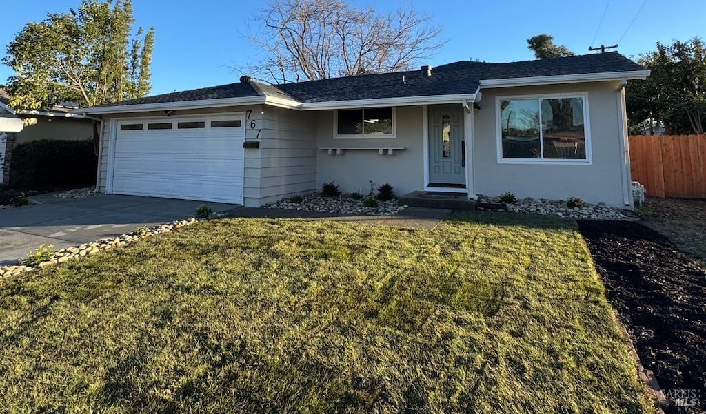 ranch-style house with a garage and a front yard