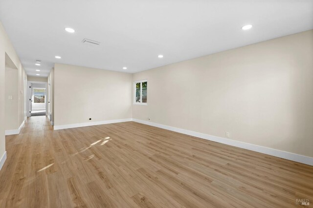 unfurnished room with light hardwood / wood-style floors