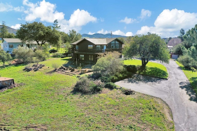 exterior space featuring a mountain view and driveway