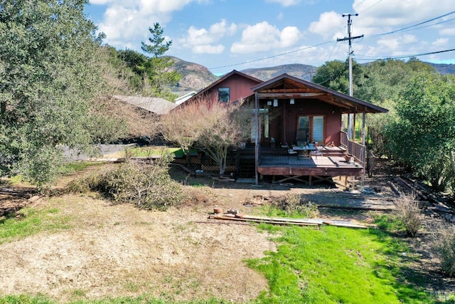 back of house with a deck with mountain view