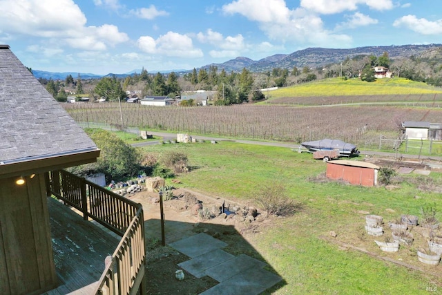 view of yard with a rural view and a mountain view