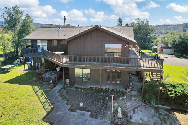 rear view of property with stairway, a lawn, and a wooden deck