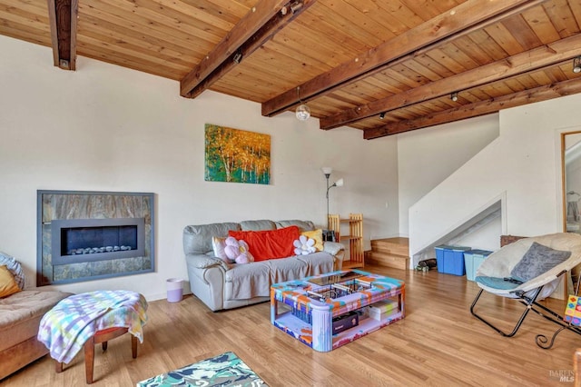 living area featuring light wood-type flooring, wooden ceiling, beam ceiling, and track lighting