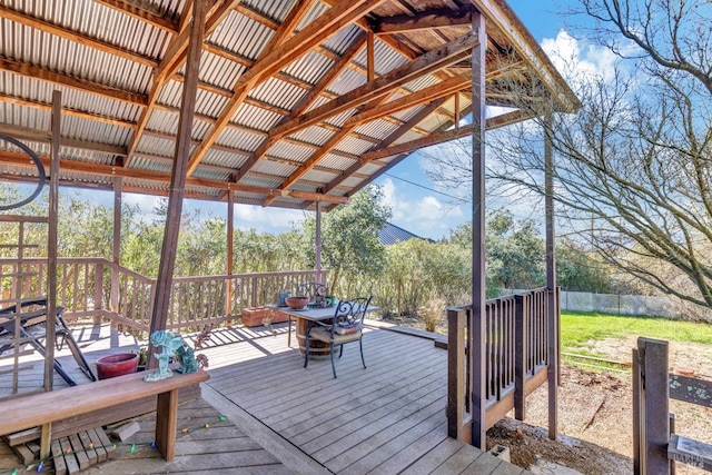 wooden deck with a fire pit and fence