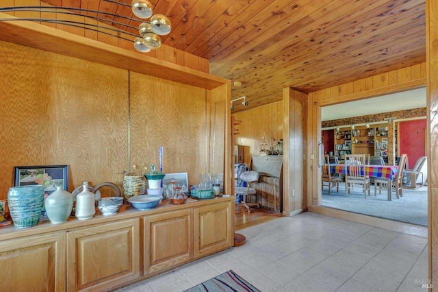 bathroom featuring wooden ceiling, tile patterned floors, vanity, and wood walls