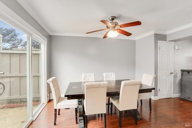 dining space with ceiling fan, ornamental molding, and dark hardwood / wood-style floors