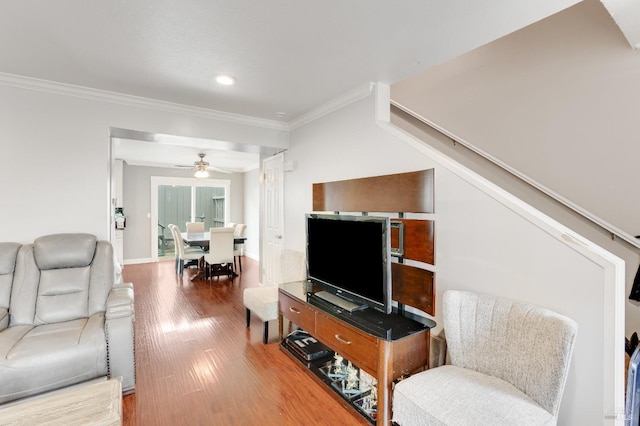 living room with crown molding, hardwood / wood-style floors, and ceiling fan