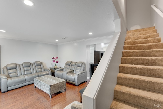 living room with crown molding and wood-type flooring