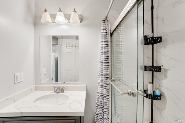 bathroom with vanity and tiled shower