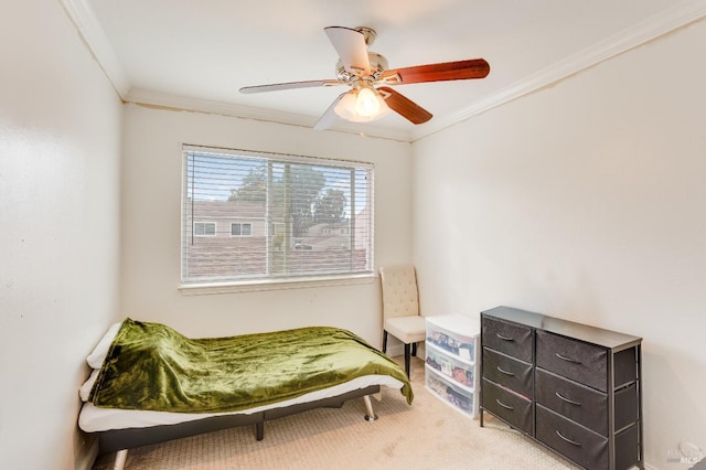 bedroom featuring ornamental molding, light colored carpet, and ceiling fan