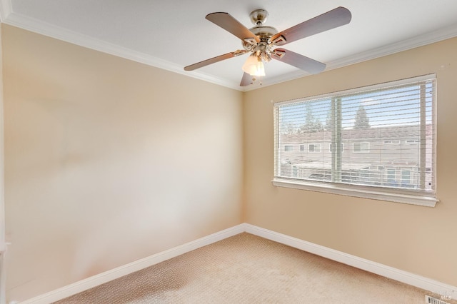 carpeted spare room with ornamental molding and ceiling fan