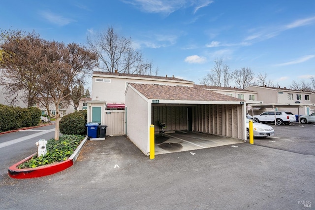 view of parking / parking lot featuring a carport