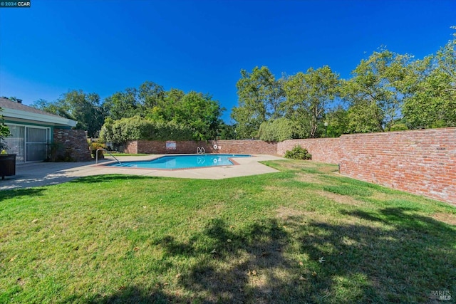 view of pool featuring a lawn