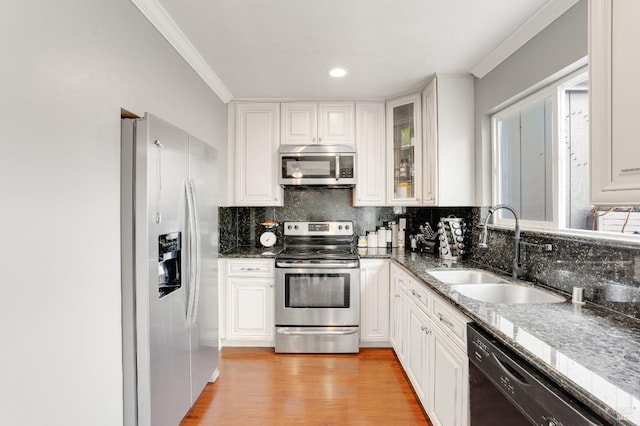 kitchen with white cabinetry, sink, and stainless steel appliances